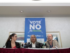 Former British Columbia premier Ujjal Dosanjh, centre, Amy Robichaud, left, and No B.C. Proportional Representation Society President Bill Tieleman, right, attend a news conference, in Vancouver, on Thursday June 28, 2018.