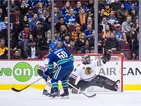 Vancouver Canucks' Brendan Gaunce (50) scores against Chicago Blackhawks goalie Corey Crawford during the third period of an NHL hockey game in Vancouver, on Wednesday October 31, 2018.