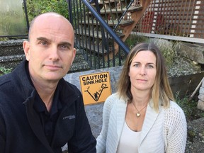 Ross and Erin Storey are paying a mortgage on a house they can't set foot in after a sink hole opened up in their front yard in Sechelt.