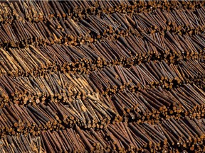 Logs are seen in an aerial view stacked at the Interfor sawmill, in Grand Forks, B.C., on May 12, 2018. Interfor Corp. says it plans to cut production by about 20 per cent across its sawmills in the B.C. interior as it faces declining lumber prices and higher log costs.