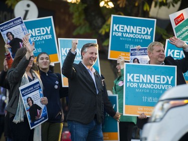 Independent candidate for Mayor of Vancouver Kennedy Stewart (centre) waves to drivers on Davie St, Oct. 20, 2018.