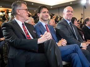 LNG Canada CEO Andy Calitz, left, Canadian Prime Minister Justin Trudeau and B.C. Premier John Horgan, right, sit together during an LNG Canada news conference in Vancouver on Tuesday, Oct. 2.