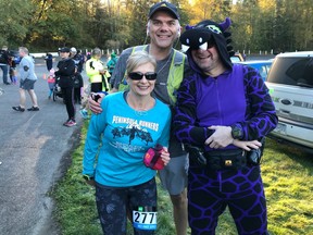 Soraya Spier and Glenn Rideout hang out with "race dinosaur" Richard MacLachlan at the MEC Langley event held Sunday morning at Campbell Valley Regional Park. More than 350 runners competed in half marathon, 10K and 5K races that started and finished at Langley Historic Speedway.