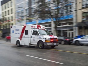 An ambulance races down E. Hastings Street in Vancouver.