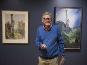 Ian Thom, former chief curator - historical, is shown on his last media tour Sept. 20, 2018 at the Vancouver Art Gallery. He's standing in front of two works by Emily Carr depicting the same scene: on the left, a 1928 watercolour; on the right, a 1937 oil painting. The difference between the two shows how Carr's artistic vision changed over time.