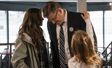 Mike Little shares a moment with his daughters Annie (left) and Alison at his election headquarter in North Vancouver, Oct., 20, 2018.
