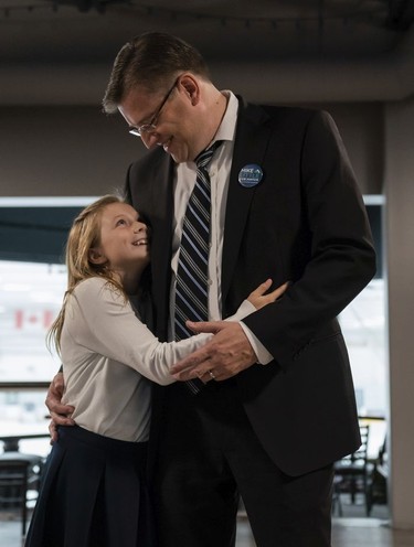 Mike Little gets a hug from his daughter Alison at his election headquarters in North Vancouver, Oct., 20, 2018.