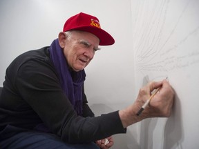 Renowned Canadian conceptual artist Garry Neill Kennedy, who lives with dementia, draws all the names of people he can remember on the wall of the CSA Space.