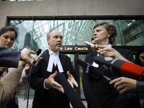 Lawyers Mark Jette (left) and Marilyn Sandford speak to a crowd in Vancouver in 2015 after John Nuttall and Amanda Korody were found guilty in a B.C. Legislature bomb plot.