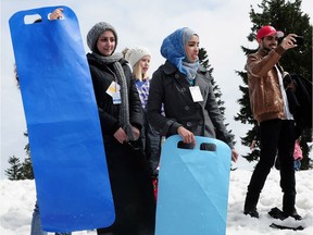 FILE PHOTO: A group of Syrian refugees enjoy what is for some of them their first snow experience at Mt. Seymour in North Vancouver, B.C. April 3, 2016.