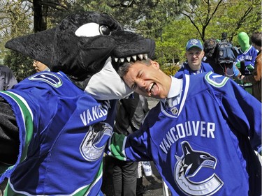 Fin takes a bite out of Mayor Gregor Robertson during a celebration of Vancouver Canuck Day at City Hall on April 27, 2010.