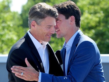 Prime Minister Justin Trudeau greets Vancouver mayor Gregor Robertson as they make a transit announcement in Surrey on Sept. 4, 2018.