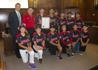 South Vancouver Little League team poses for a photo with Mayor Gregor Robertson after being honoured at Vancouver City Hall Tuesday in Vancouver, BC, September, 16, 2014.