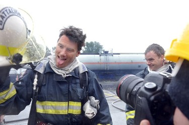 Vancouver Mayor Gregor Robertson reacts as he emerges from a fireman's breathing apparatus as political leaders joined the Vancouver Fire & Rescue Services working together with the BC Professional Fire Fighters Association and the International Association of Fire Fighters, at a Fire Ops 101 session at the Chess Street Training Facility on Monday Sept. 26, 2011.