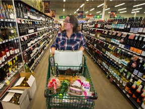 Customer Jaime Clinker shops wines in the wine section of Save On Foods in Surrey, BC, Oct. 1, 2018.