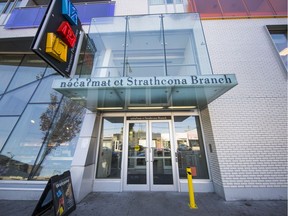 A sign outside Strathcona Public Library shows its English and Indigenous names.