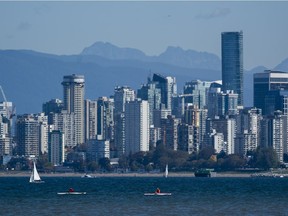 Kayakers take to the waters of Burrard Inlet on a clear and sunny day in Vancouver,