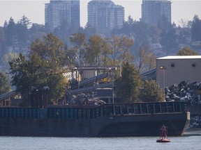 The 76-metre barge remains moored in the Fraser River as an investigation into the cause of the fire gets underway.