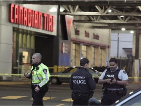 Vancouver police investigate a scene at Canadian Tire on Grandview Highway after a robbery suspect was shot after stabbing an officer during a robbery attempt in Vancouver, BC., November 10, 2016.