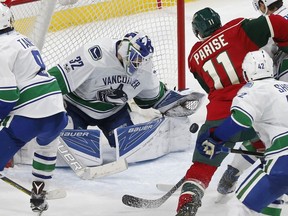 Richard Bachman stops the Wild's Zach Parise enroute to backstopping the Vancouver Canucks to a 3-2 win in St. Paul, Minn., on March 25, 2017.