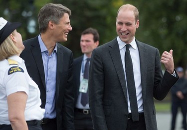 The Duke of Cambridge, Prince William, shares a laugh with Vancouver Mayor Gregor Robertson and a member of the Canadian Coast Guard during a visit to the Kitsilano Coast Guard station on Sept. 25, 2016.