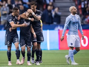 Vancouver Whitecaps' Jake Nerwinski, from left, Felipe Martins and Jose Aja celebrate Felipe's goal, but Sporting Kansas City's Yohan Croizet, right, tied the game 1-1 in the 62nd minute and his teammate Khiry Shelton scored the winner 20 minutes later to eliminate Vancouver from the post-season picture.