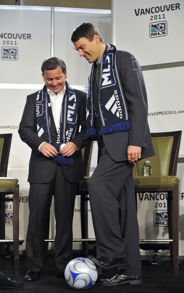 Whitecaps co-owner Jeff Mallett (left) and Vancouver mayor Gregor Robertson kick a soccer ball around Wednesday March 18, 2009, at a press conference announcing that the Whitecaps will become a Major League Soccer team in 2011.