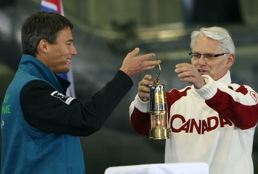 The Olympic Torch arrives at the Victoria International Airport on a Canadian Forces CC-150 Polaris. Mayor Gregor Robertson passes the torch to B.C. premier Gordon Campbell during a ceremony at the 433 Maritime Helicopter Squadron hangar.