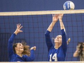 Belmont Bulldogs Taylee Pomponio,left, and Gracie May block the ball against the Oak Bay Bays in Island AAAA girls volleyball championship at Belmont Secondary School in Victoria, B.C. November 18, 2017.