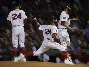 This multiple exposure shows Boston Red Sox pitcher David Price throwing during Game 2 of the World Series game against the Los Angeles Dodgers on Oct. 24 at Fenway Park in Boston. Boston won Game 2 4-2 and Price picked up the victory.