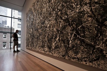 A visitor checks out a Jackson Pollock inside the Museum of Modern Art (MOMA).