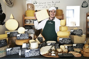 Andy Swinscoe with a fine collection of cheeses inside The Courtyard Dairy in Settle.