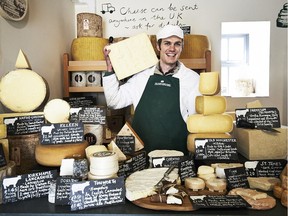 Andy Swinscoe with a fine collection of cheeses inside The Courtyard Dairy in Settle.
