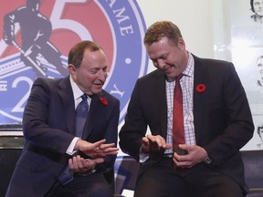 NHL commissioner Gary Bettman, left, and Martin Brodeur look at their Hockey Hall of Fame rings during a news conference on Nov. 9 in Toronto.