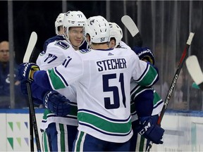 Nikolay Goldobin is congratulated Troy Stecher and Tyler Motte after scoring his second goal of the season.