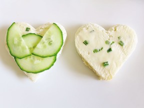 Paper-thin cucumber slices and best-quality butter are the keys to cucumber sandwiches, garnished here with a strip of chives and puffs of fresh dill.