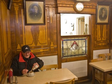A customer enjoys a cup of tea inside E.Pellicci.