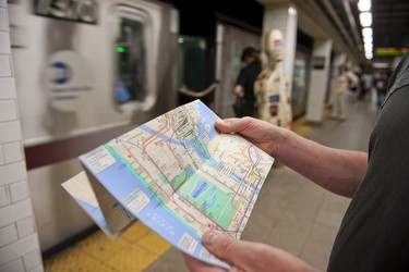 A visitor checks out a New York city subway map.