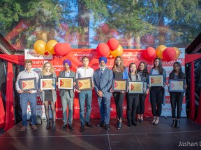 Baldev Singh Bath of Basant Motors is flanked by young students during the dealership's annual scholarship ceremony on Oct. 13.