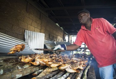 A worker attends to the jerk chicken at Scotchies, Montego Bay.