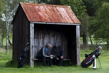 Two golfers take a break before teeing off on the par-3 5th at Gifford Golf Club.