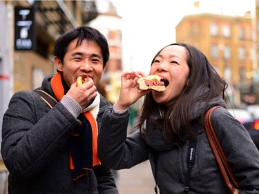 Enjoying hot salt-beef bagels from Beigel Bake.