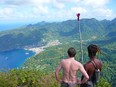 A walker and his guide takes in the magnificent views from the summit of Petit Piton.