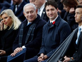 Israeli Prime Minister Benjamin Netanyahu (2nd L) and Canadian Prime Minister Justin Trudeau (3rd R) attend a ceremony at the Arc de Triomphe in Paris on November 11, 2018 as part of commemorations marking the 100th anniversary of the 11 November 1918 armistice, ending World War I.