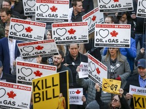 Pro-pipeline protesters gather and chant slogans outside a venue where Federal Finance Minister Bill Morneau was speaking in Calgary, Alta., Tuesday, Nov. 27, 2018..