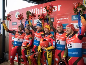 Germany's Toni Eggert, 3rd left, and Sascha Benecken, 4th left, celebrate their first-place finish with fellow Germans, second-place finishers Robin Johannes Geueke, left, and David Gamm, 2nd left, and third-place finishers Tobias Wendl, 2nd right, and Tobias Arlt, right, during a Luge World Cup doubles event in Whistler, B.C., on Friday November 30, 2018.