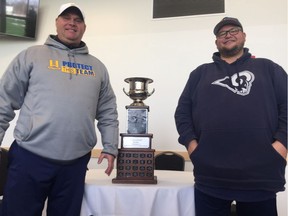Saskatoon Hilltops head coach Tom Sargeant and Langley Rams head coach Howie Zaron pose with the Canadian Bowl trophy prior to the 2018 Canadian Bowl in Saskatoon.