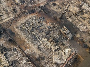 Debris and residences leveled by the wildfire line a neighborhood in Paradise, Calif., on Thursday, Nov. 15, 2018.