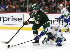 Centre Mikko Koivu of the Minnesota Wild eludes the check of Vancouver Canucks' Elias Pettersson during Thursday's NHL game in St. Paul, Minn. The Canucks ended a six-game road trip with a 6-2 loss.