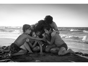 Marco Graf as Pepe, left to right, Daniela Demesa as Sofi, Yalitza Aparicio as Cleo, Marina De Tavira as Sofia, Diego Cortina Autrey as Tono, Carlos Peralta Jacobson as Paco are shown in a scene from "Roma" written and directed by Alfonso Cuaron in this handout photo. With director Alfonso Cuaron's sweeping epic ‚ÄúRoma‚Äù floating on a cloud of positive critical buzz, the Netflix film is destined to be a major awards contender. But that doesn't mean the black-and-white Spanish-language film by the ‚ÄúGravity‚Äù Oscar-winner will be playing your local theatre.